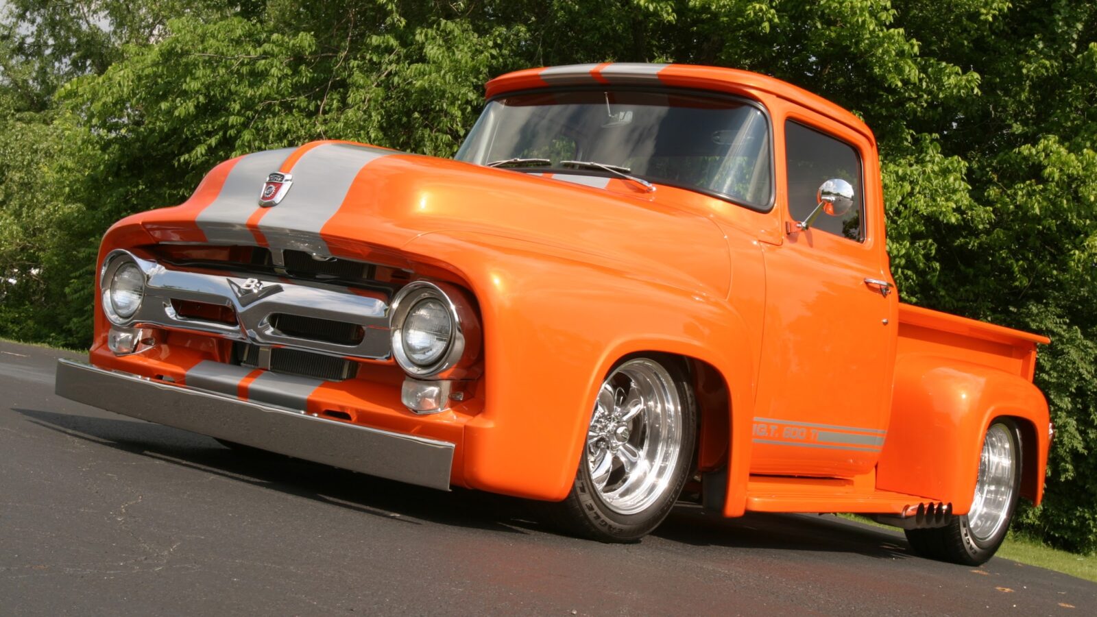 Classic orange pickup truck with racing stripes