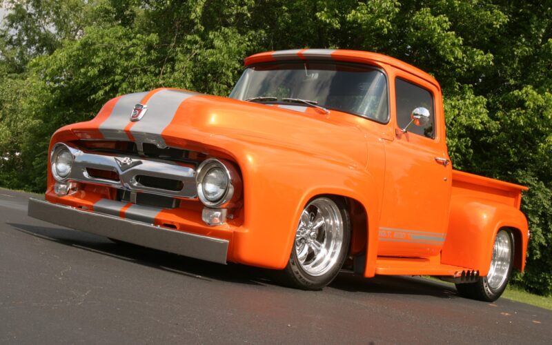 Classic orange pickup truck with racing stripes